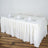 Elegant white table setup with glasses and napkins for formal dining.