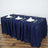 Navy blue tablecloth draped over a table set with plates and glasses.