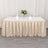 Beige tablecloth draped over a long table with floral centerpiece and plates.