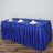 Blue tablecloth set with plates and glasses for elegant dining.