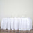 White table with elegant draping and wine glasses set for dining