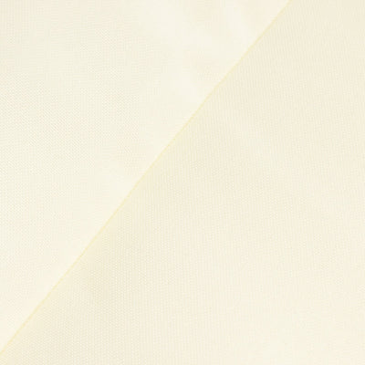 Close-up of textured cream fabric showing fine weave details.