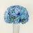 Blue floral arrangement with roses and hydrangeas in a vase.