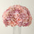 Pink and purple floral arrangement in a round shape