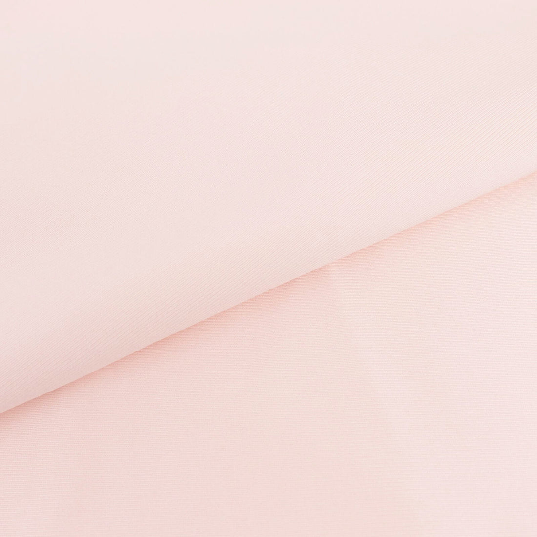 Light pink fabric with a smooth texture and folded edges.