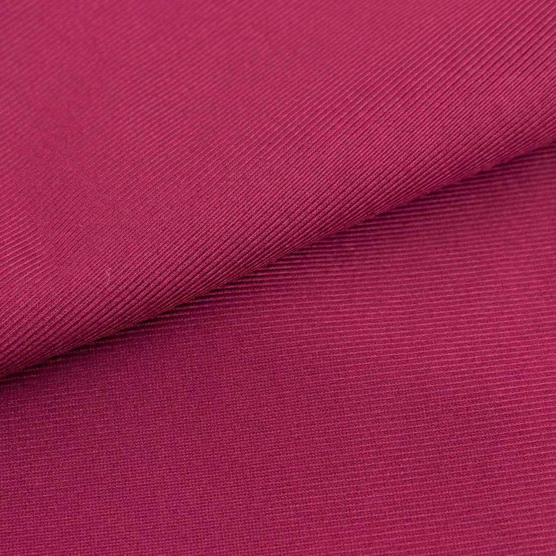Textured magenta fabric showcasing fine ribbing details.