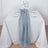 Elegant gray table runner on a white table setting with flowers and glassware.