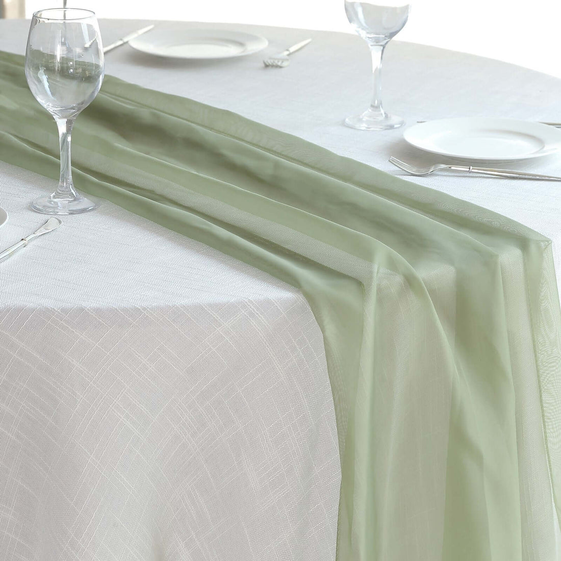 Elegant green table runner on a classic white table setting.