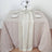 Elegant table setting with cream table runner, plates, and glassware.