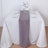 Elegant table setting with white linens and a sheer purple runner.