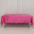 Pink velvet tablecloth on a folding table against a plain backdrop.