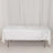 White sequin tablecloth draped over a folding table in a studio setting.