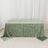 Green velvet tablecloth on a table against a plain backdrop.