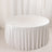 Round white table with elegant textured tablecloth