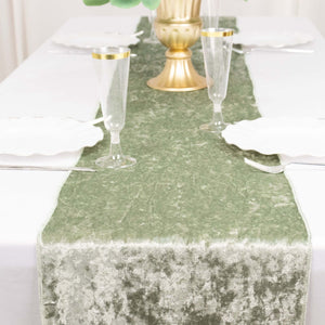 Elegant green table runner on a white dining table setting with glassware.