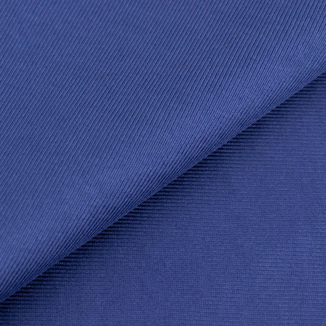 Navy blue textured fabric close-up showcasing its fine ribbed pattern.