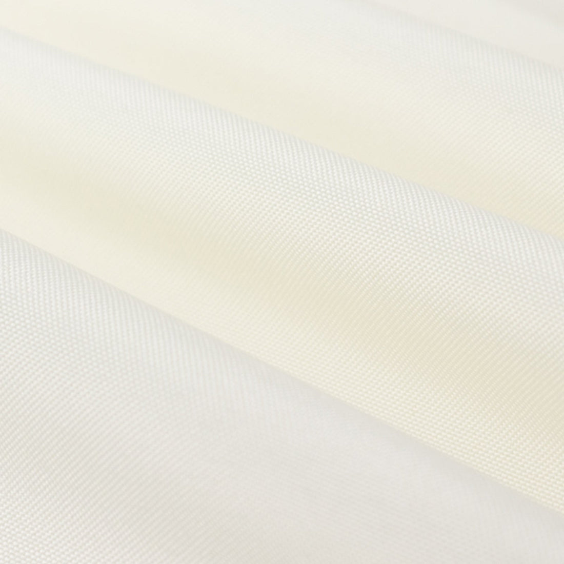 Close-up of smooth, textured fabric in soft cream color.