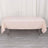 Pink tablecloth draped over a folding table in a studio setting.