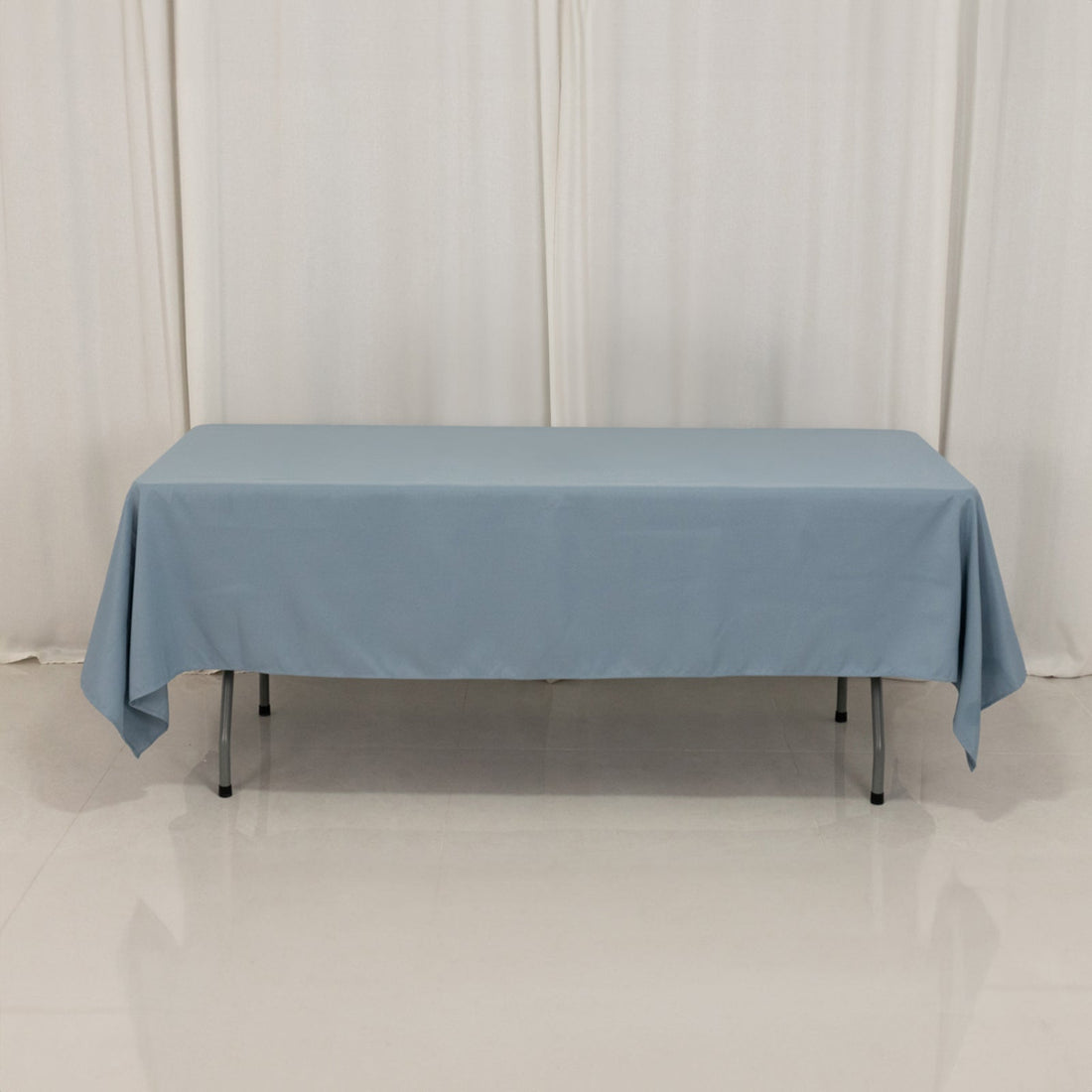 Blue tablecloth on a table in a studio setting.