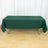 Green tablecloth draped over a folding table in a studio setting.