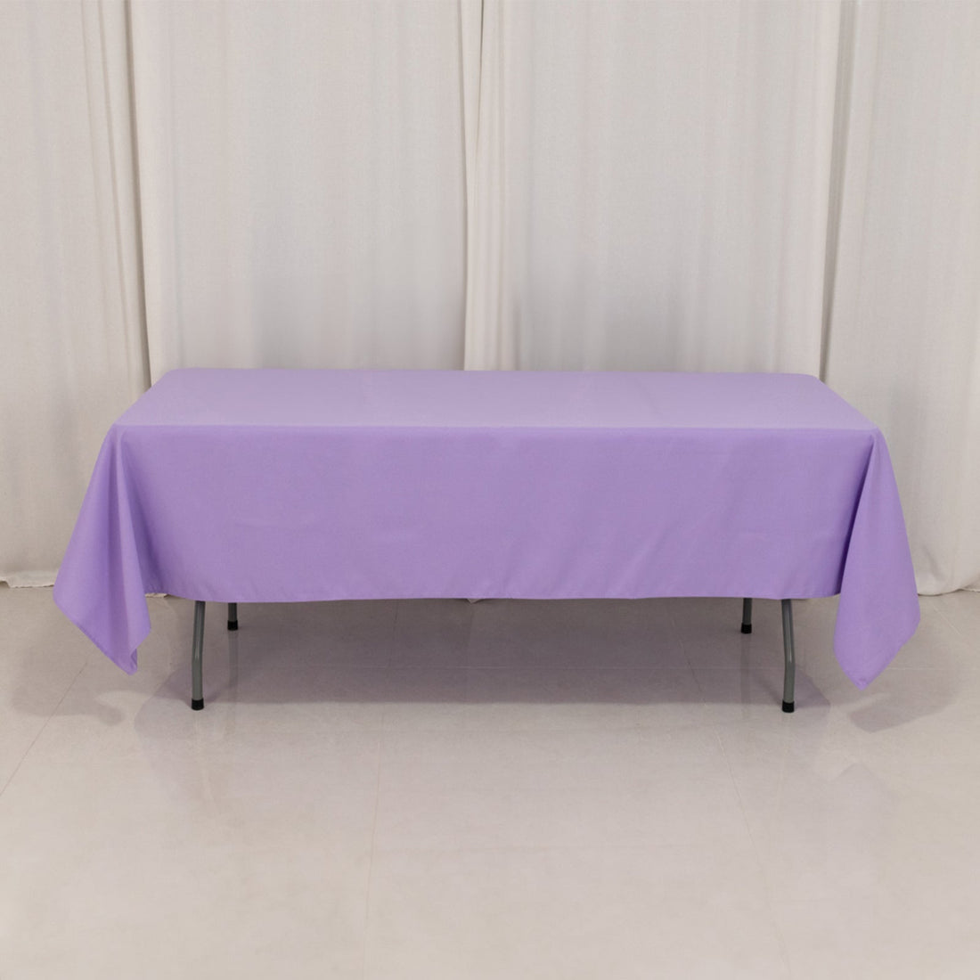Purple tablecloth draped over a rectangular table in a studio setting.