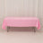 Pink tablecloth draped over a table in a studio setting.