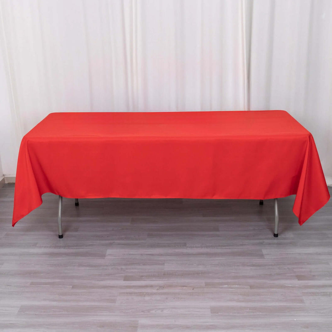 Red tablecloth on a table in a studio setting.