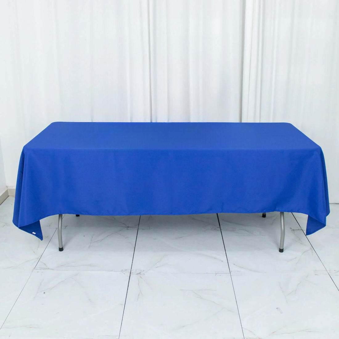 Blue tablecloth draped over a table in a studio setting.