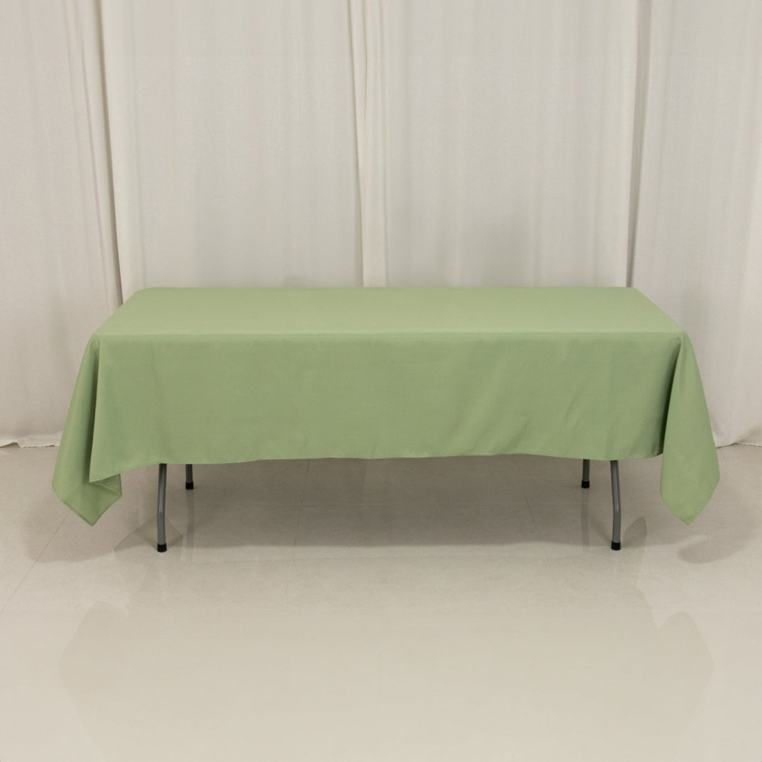 Green tablecloth on a table in a studio setting.