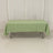 Green tablecloth on a table in a studio setting.