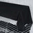 Black tablecloth draped over a table on a reflective surface.