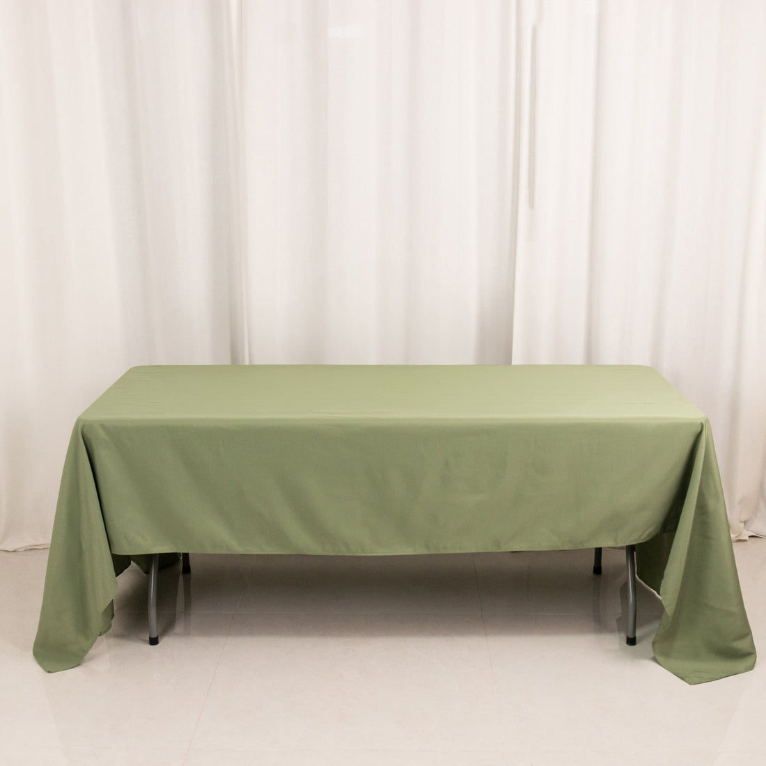 Green tablecloth on a table in a studio setting.