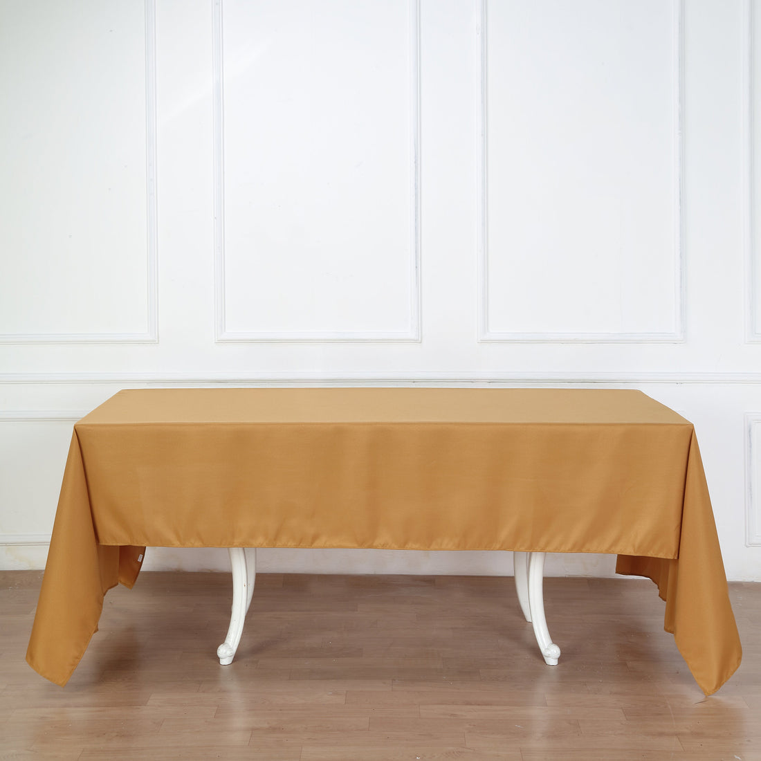 Brown tablecloth draped over a white table in a studio setting.