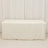 White table cover draped over a table in a studio setting.