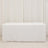 White table covered with a plain tablecloth in a studio setting.