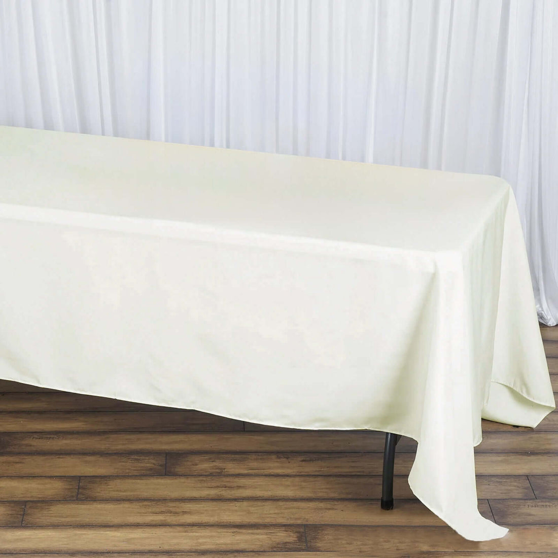 Ivory satin tablecloth draped over a table.
