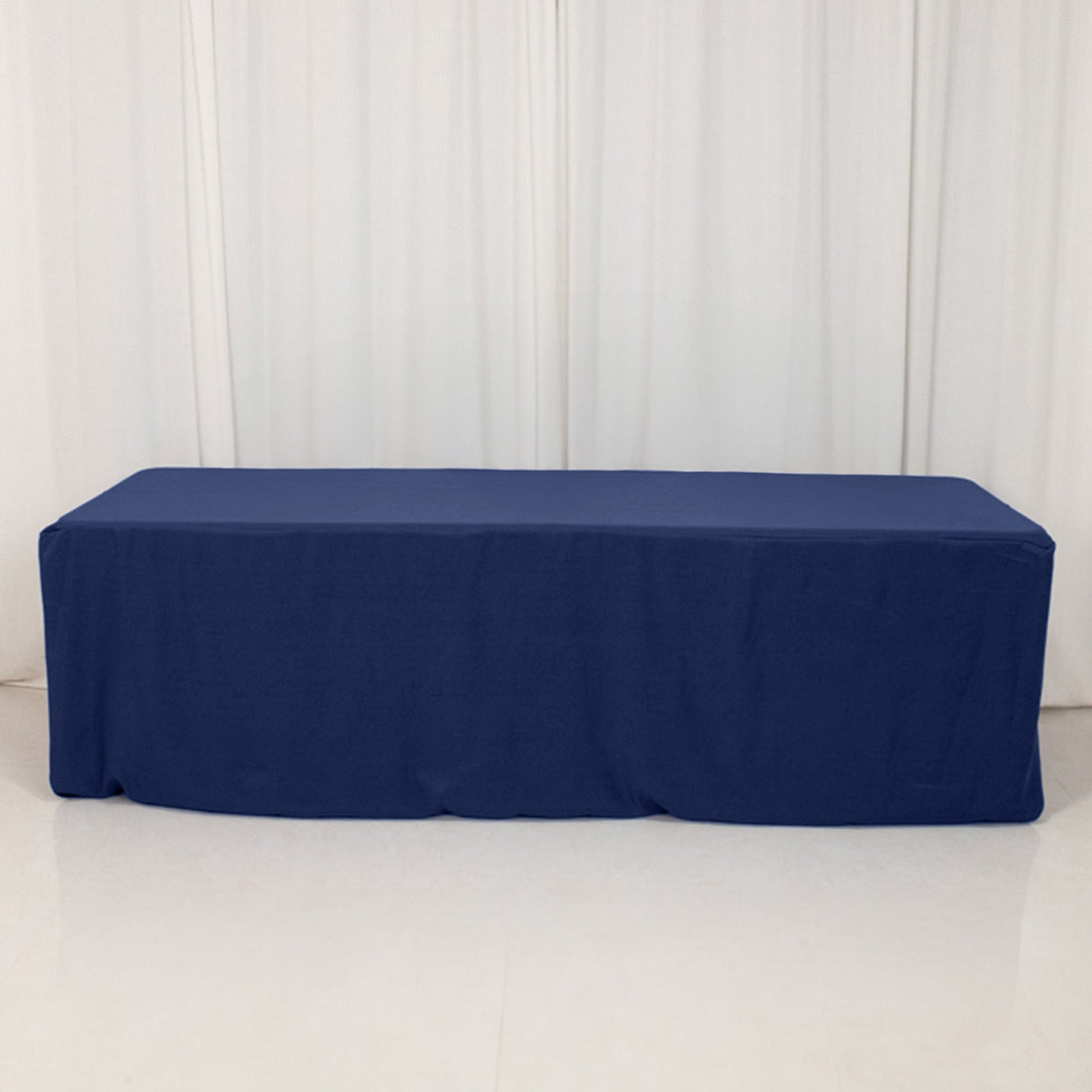 Navy tablecloth draped over a table in a studio setting