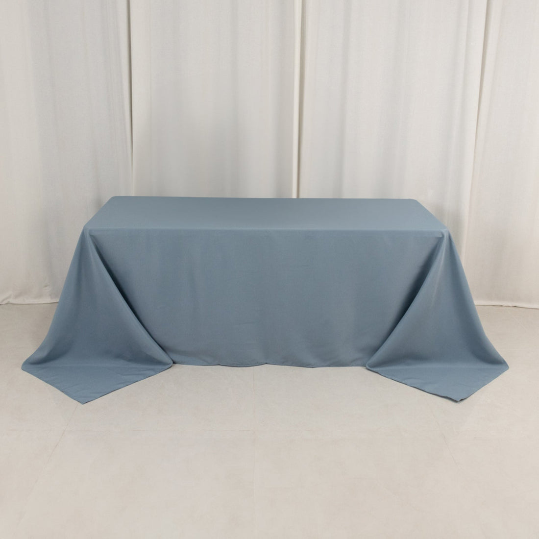 Blue tablecloth draped over a table in a studio setting.