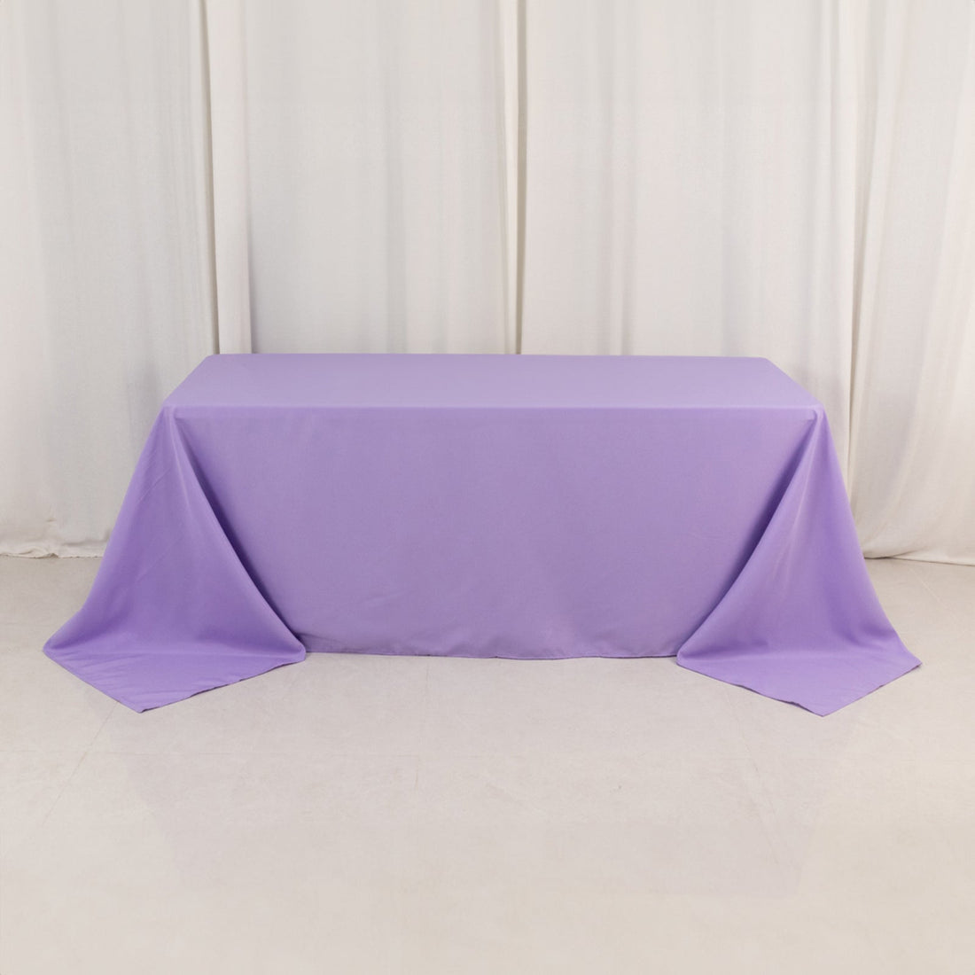 Purple tablecloth on a rectangular table in studio setting