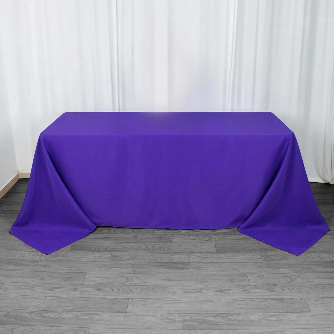 Purple tablecloth on a wooden floor backdrop.
