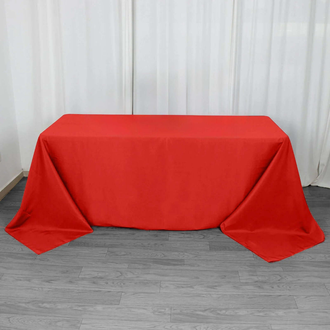 Red tablecloth draped elegantly over a table in a bright setting.