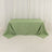 Green tablecloth draped over a table on a plain background.