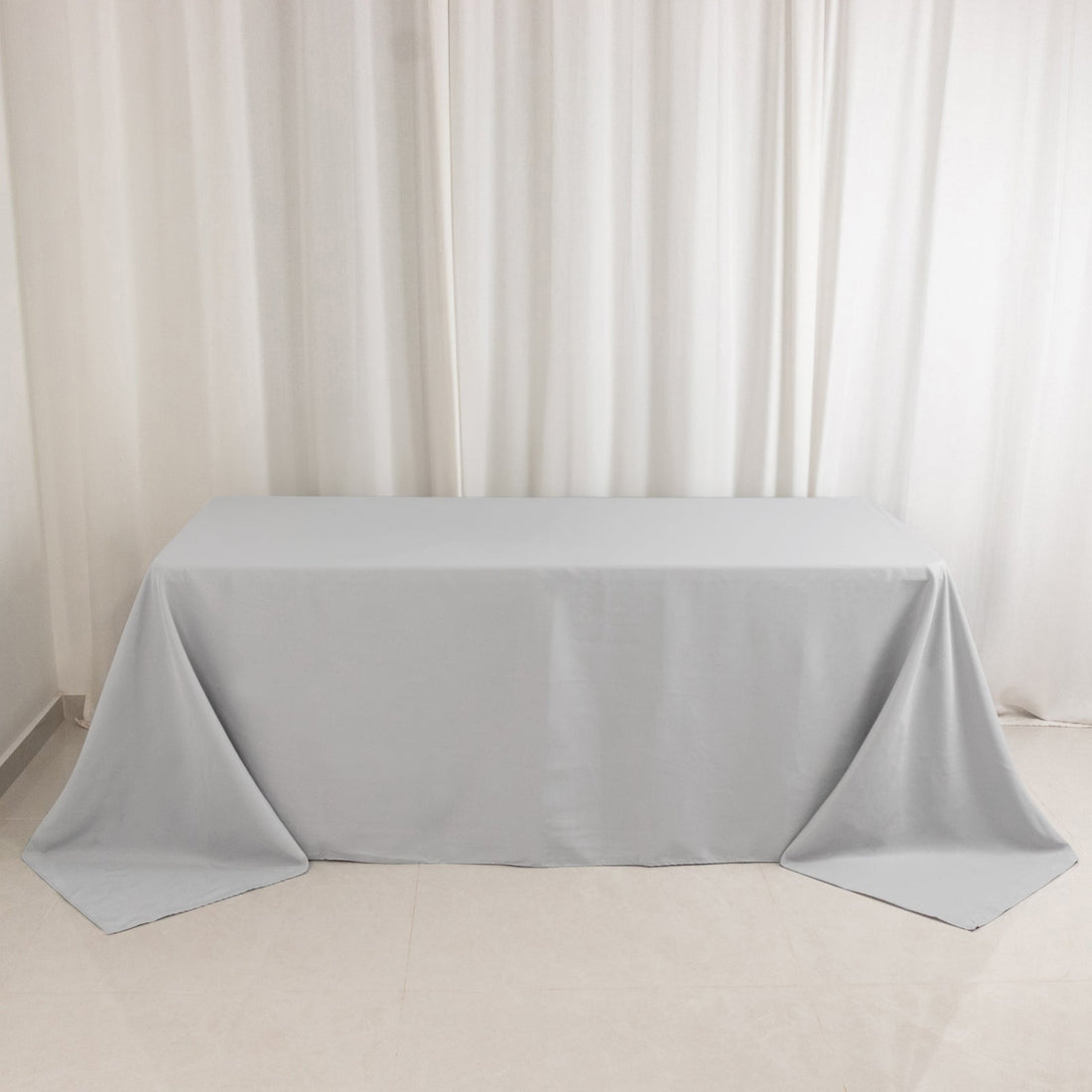 Gray tablecloth draped on a table against a plain background.