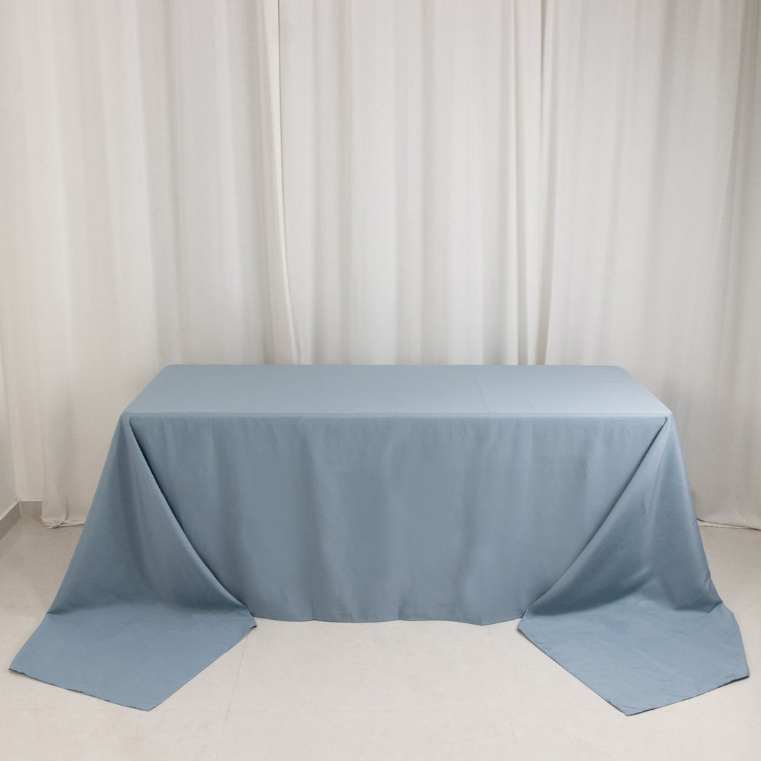 Light blue tablecloth draping over a rectangular table
