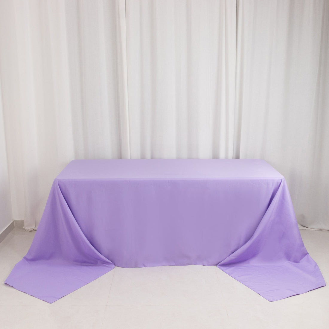 Purple tablecloth draped over a table in a bright setting.