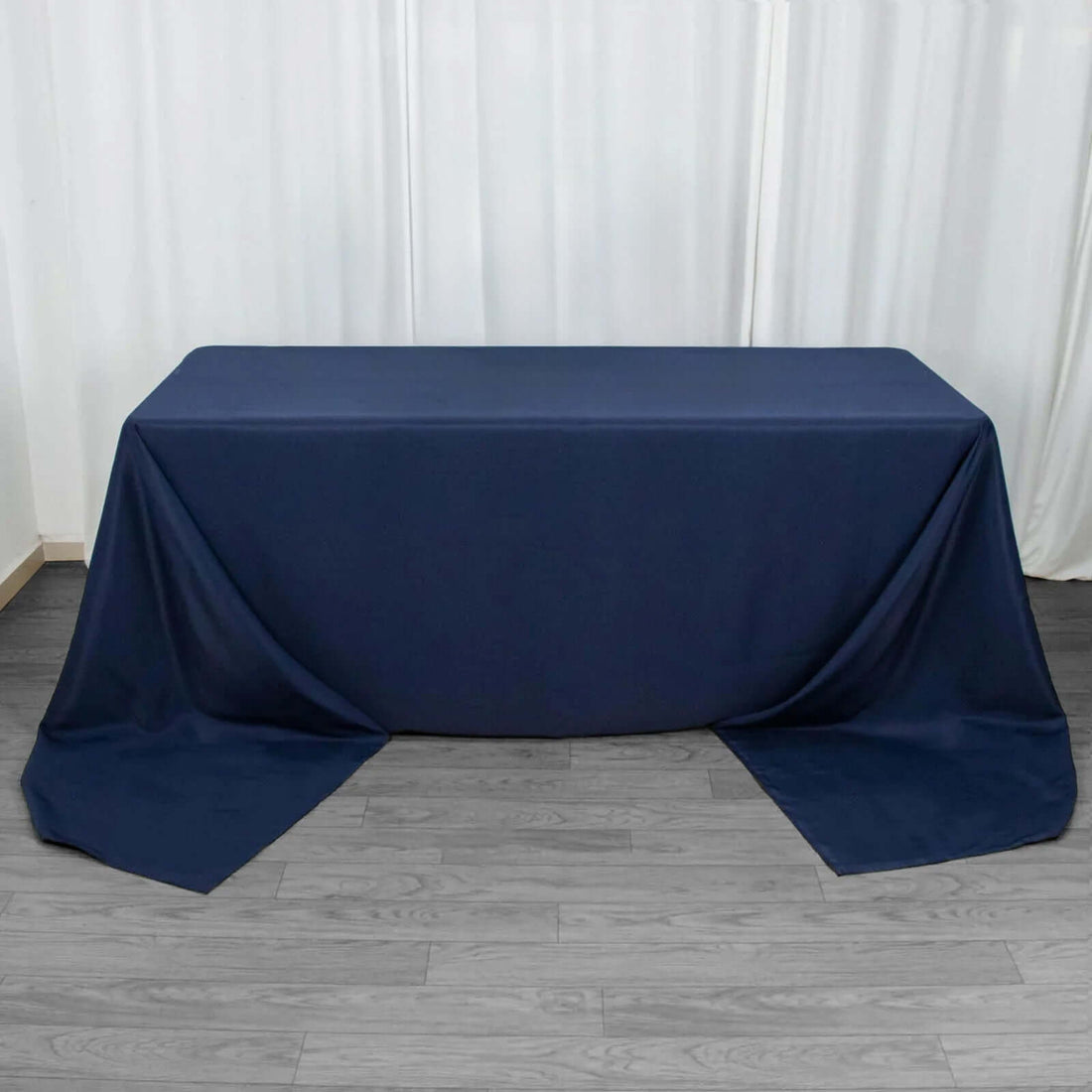 Navy blue tablecloth draped over a table in a studio setting.