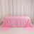 Pink tablecloth draped over a table in a bright setting.
