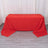 Red tablecloth draped over a table in a minimalistic setting.