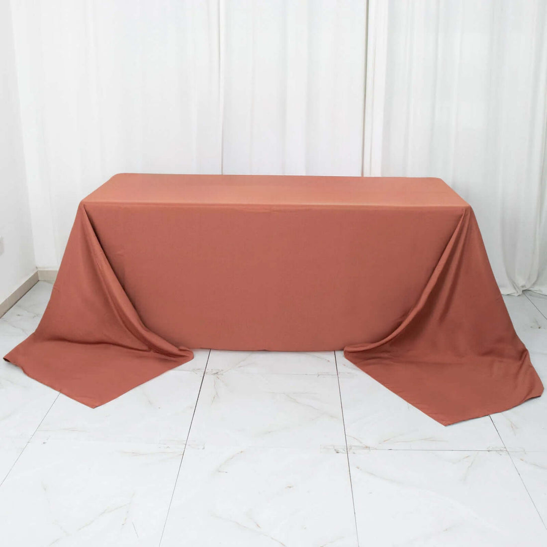 Rust-colored tablecloth draped over a rectangular table