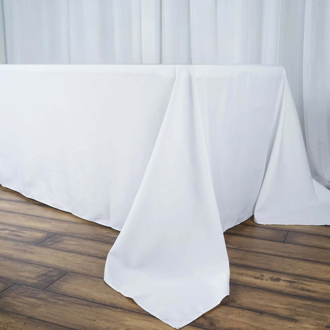 White tablecloth draped elegantly over a wooden table.
